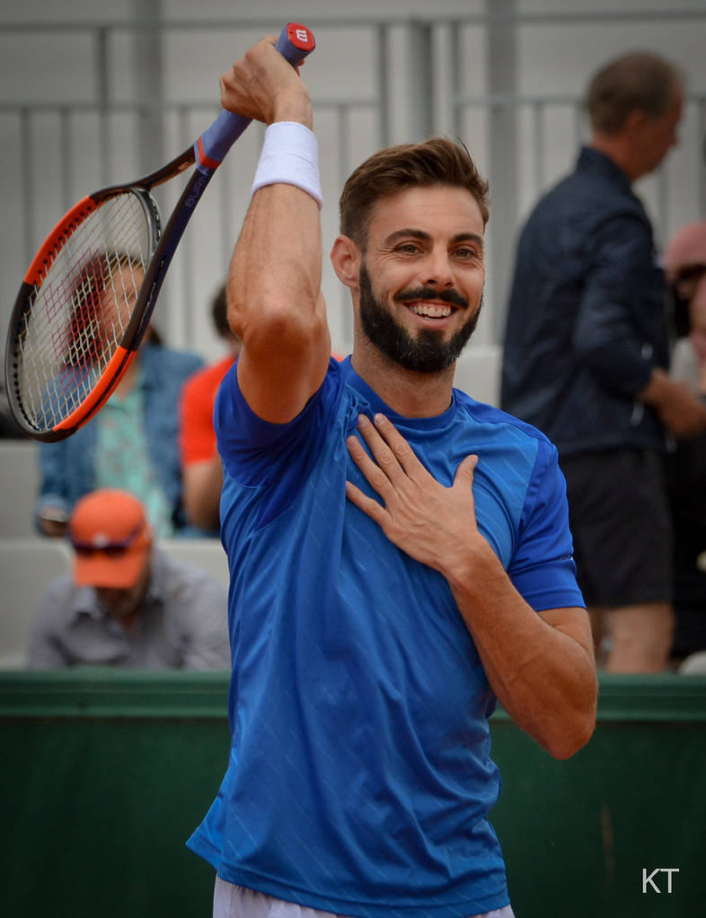 Marcel Granollers Holding His Chest And Racket Background