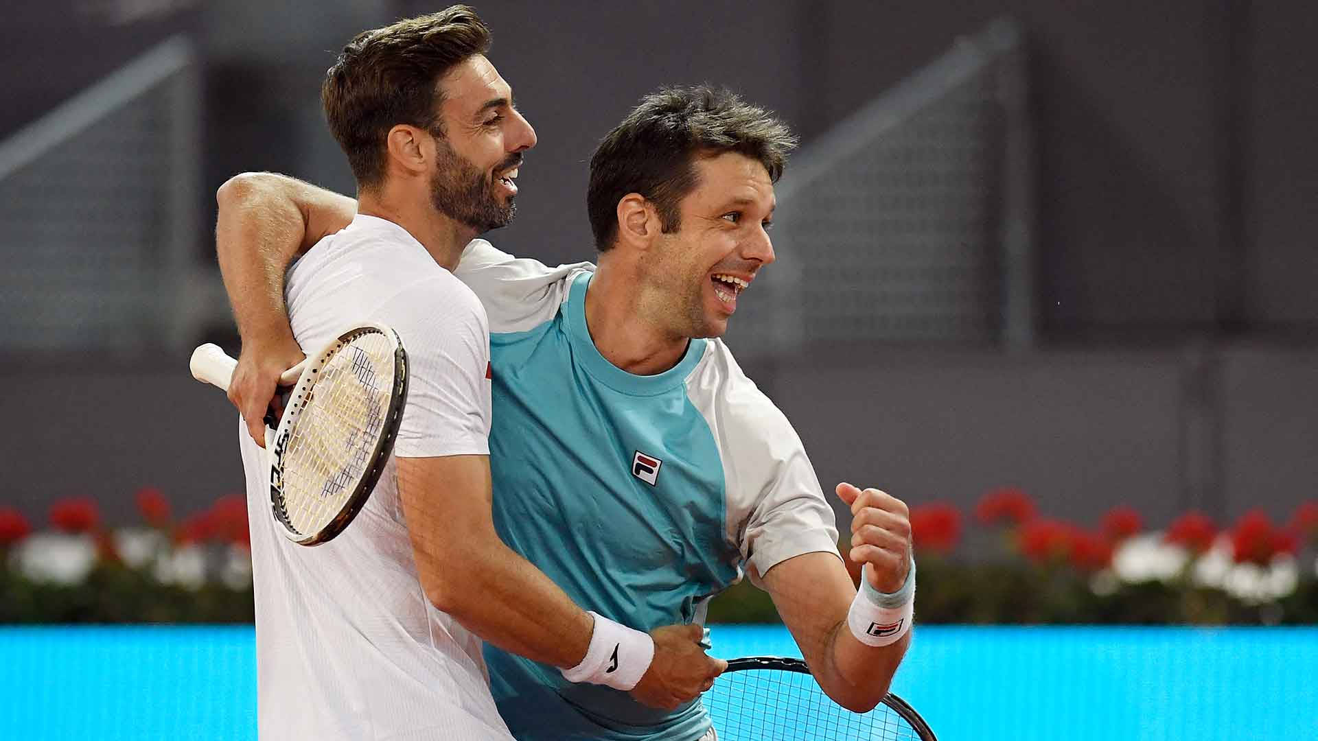 Marcel Granollers In A Celebratory Hug With Horacio Zeballos Background