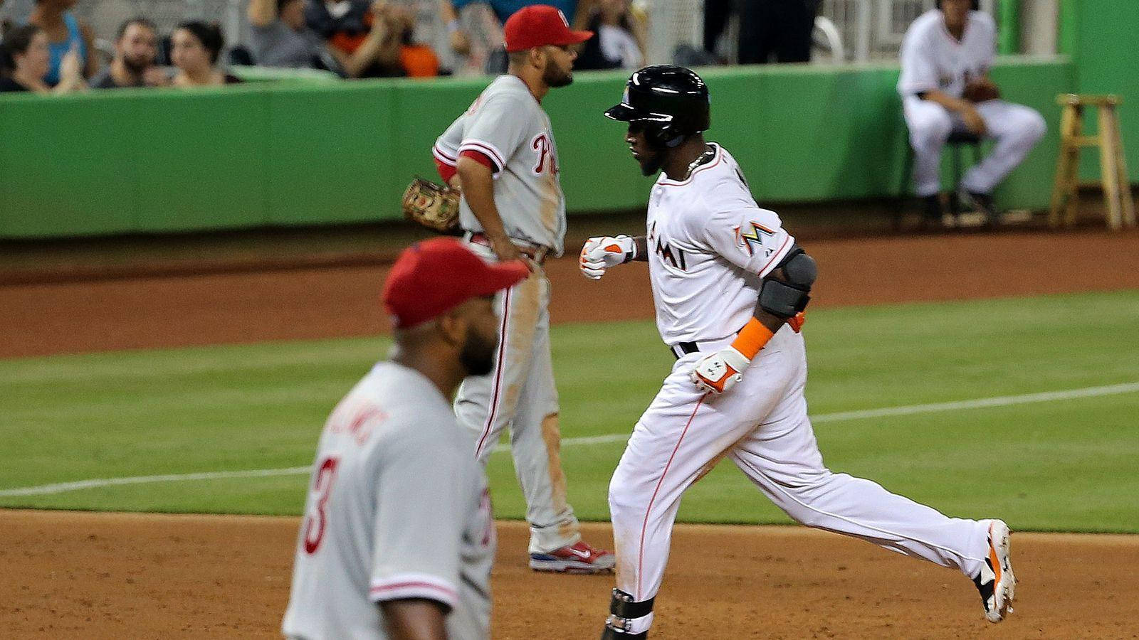 Marcell Ozuna Running Between Opponents