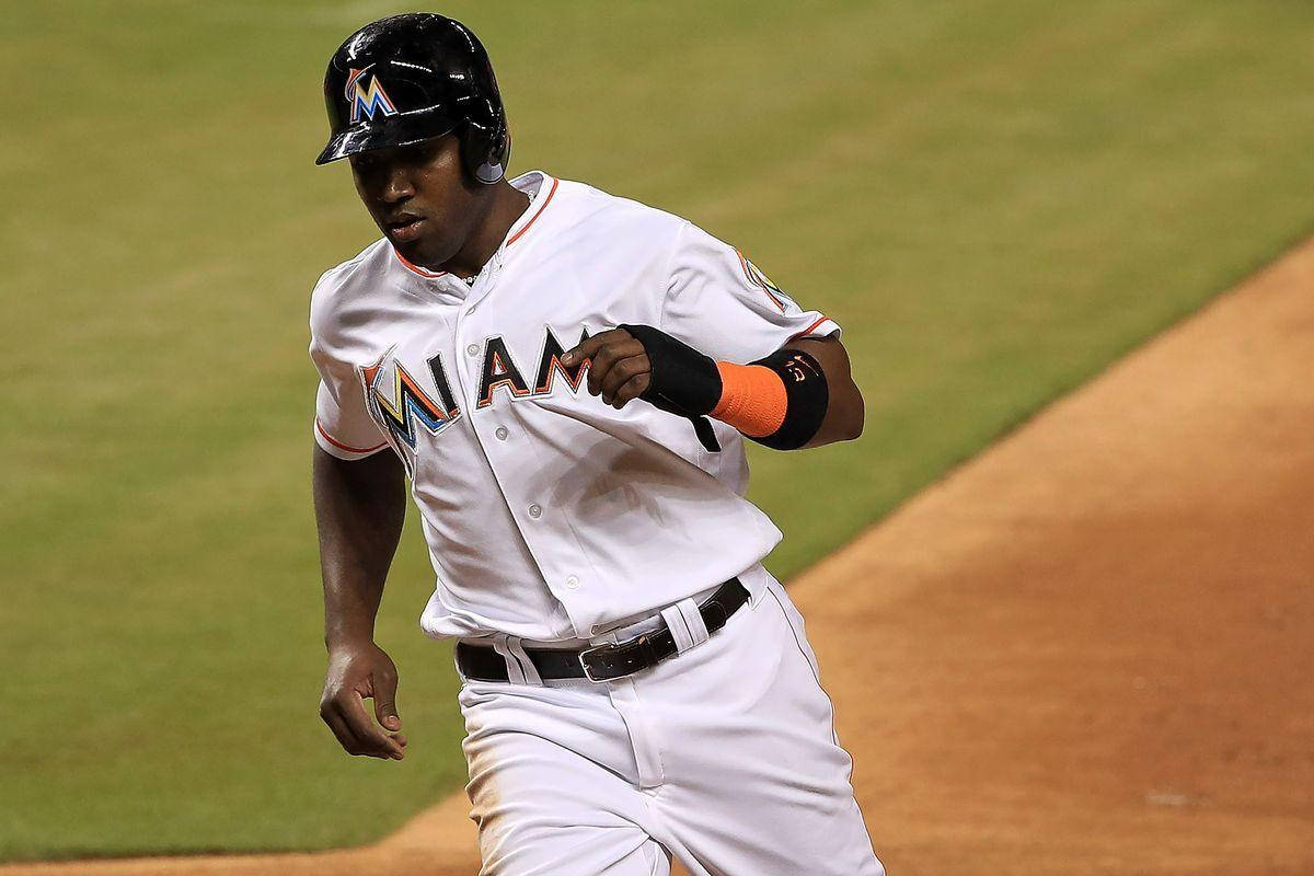 Marcell Ozuna Sprinting Across The Field In An Intense Baseball Game