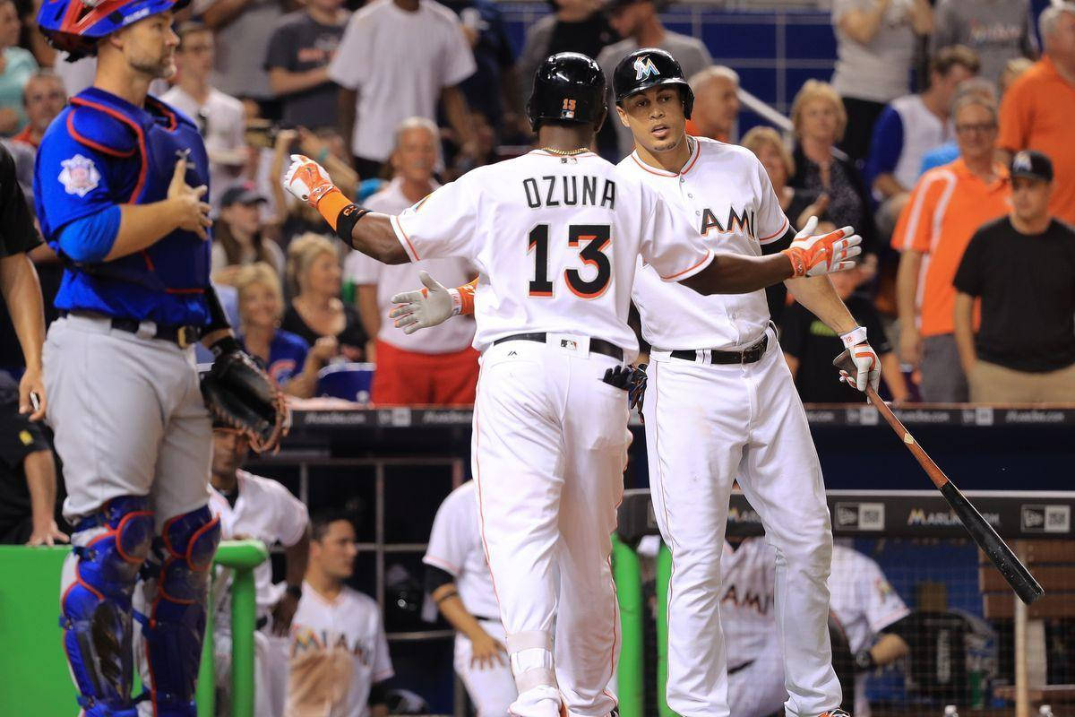 Marcell Ozuna Walking Towards Teammate