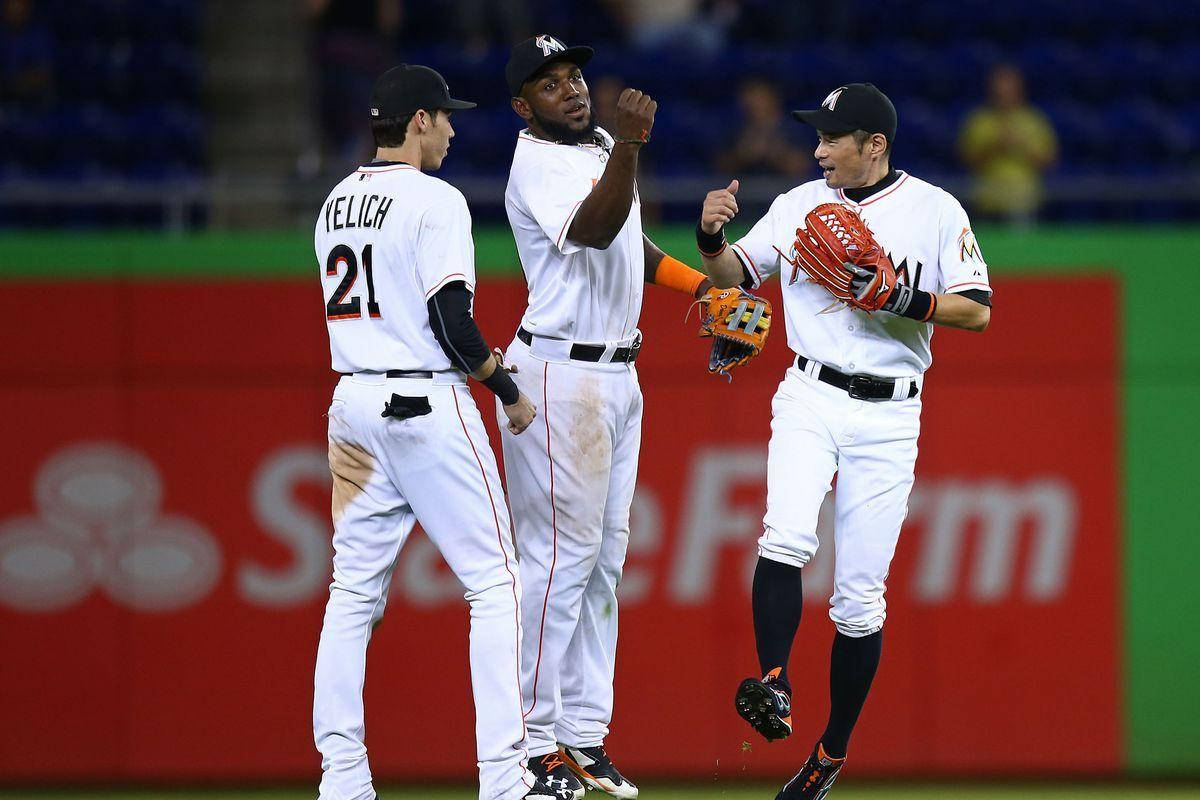 Marcell Ozuna With Two Teammates