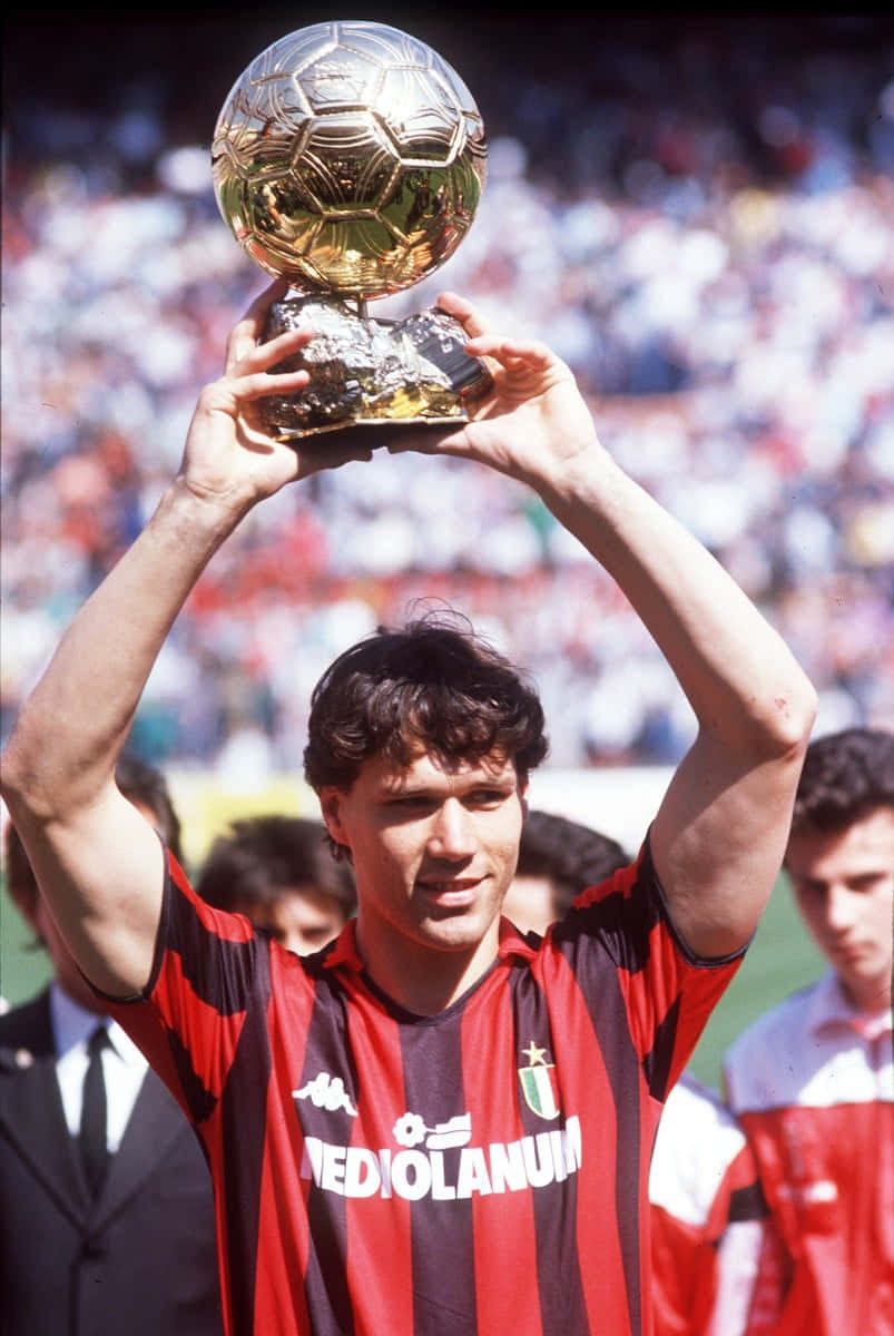 Marco Van Basten Joyfully Lifting A Trophy Background