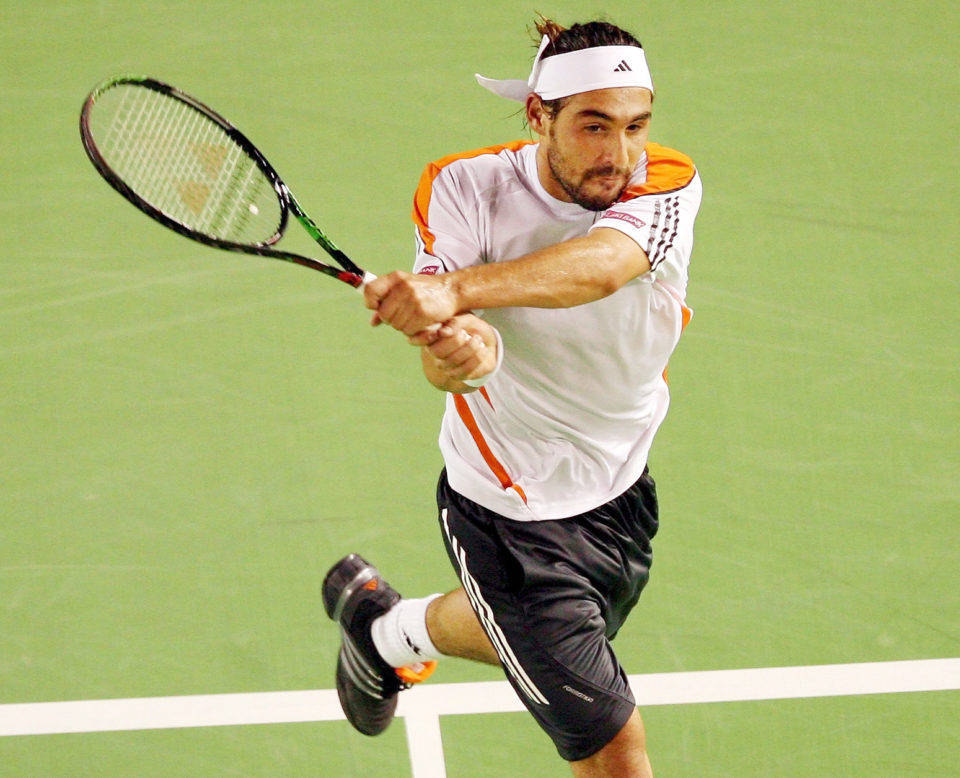 Marcos Baghdatis Executing A Two-handed Grip On The Tennis Court.