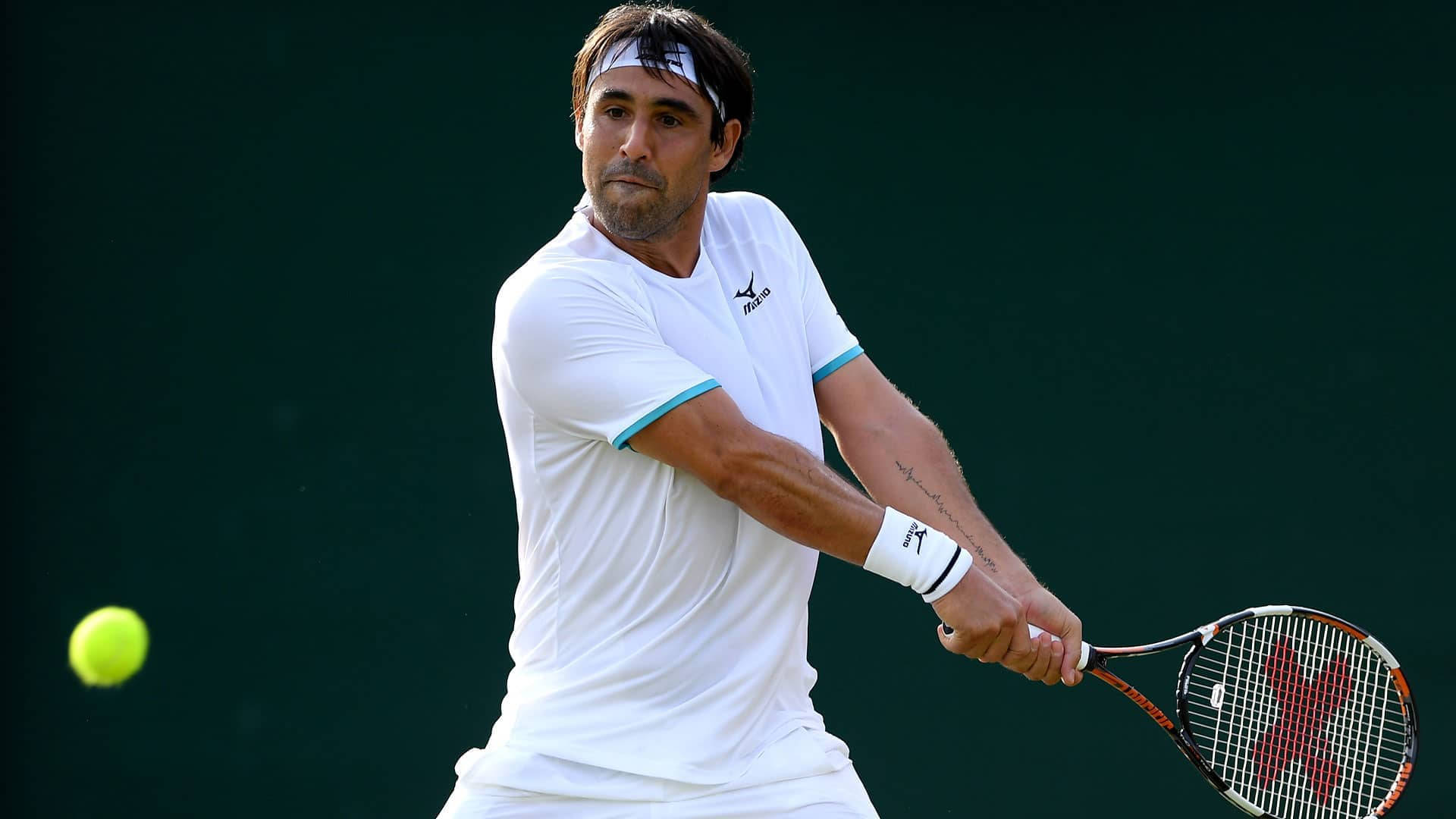 Marcos Baghdatis Expertly Preparing To Counter An Incoming Ball During A Tennis Match. Background