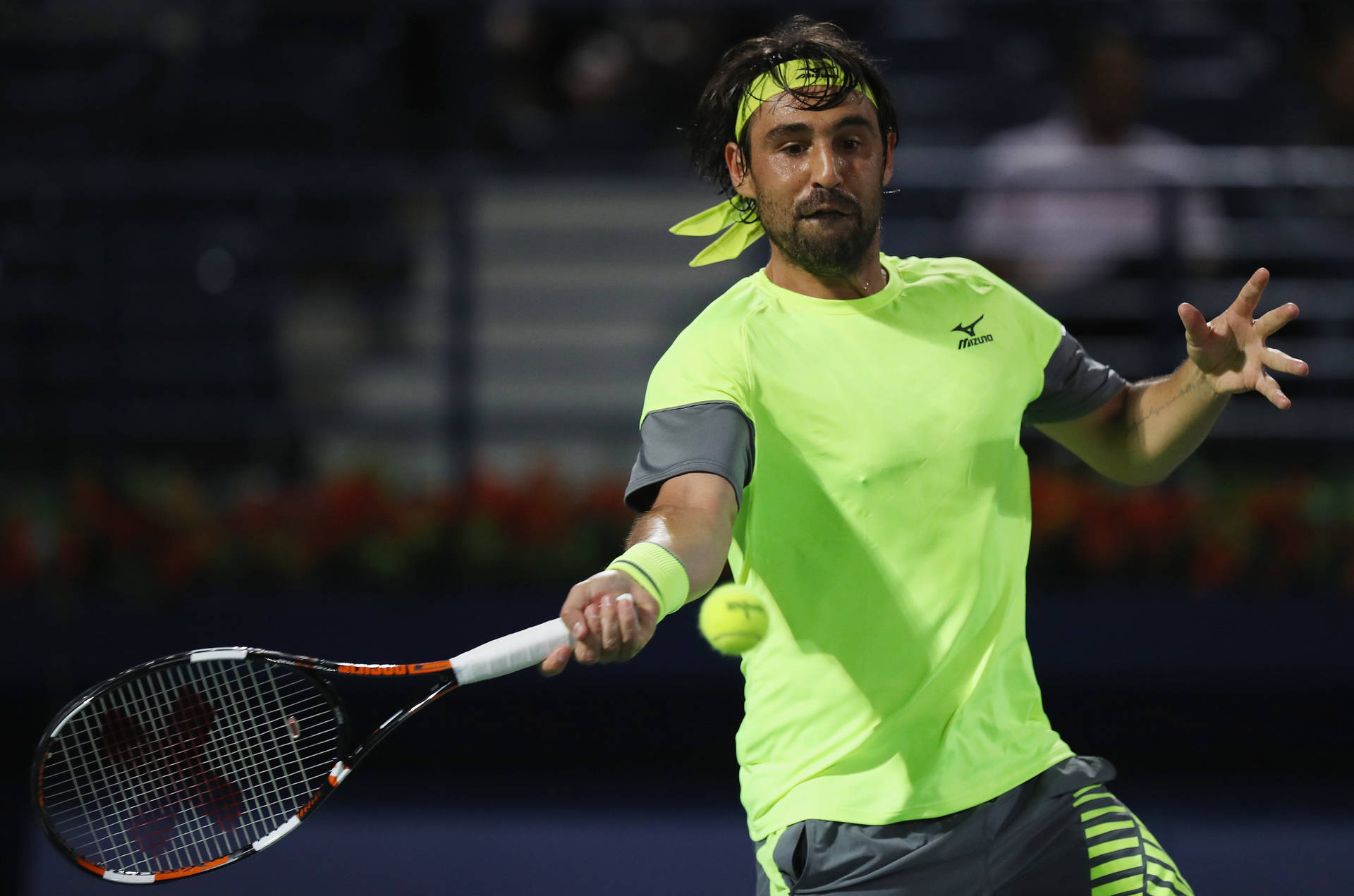 Marcos Baghdatis In Action, Speedily Aims For The Tennis Ball. Background