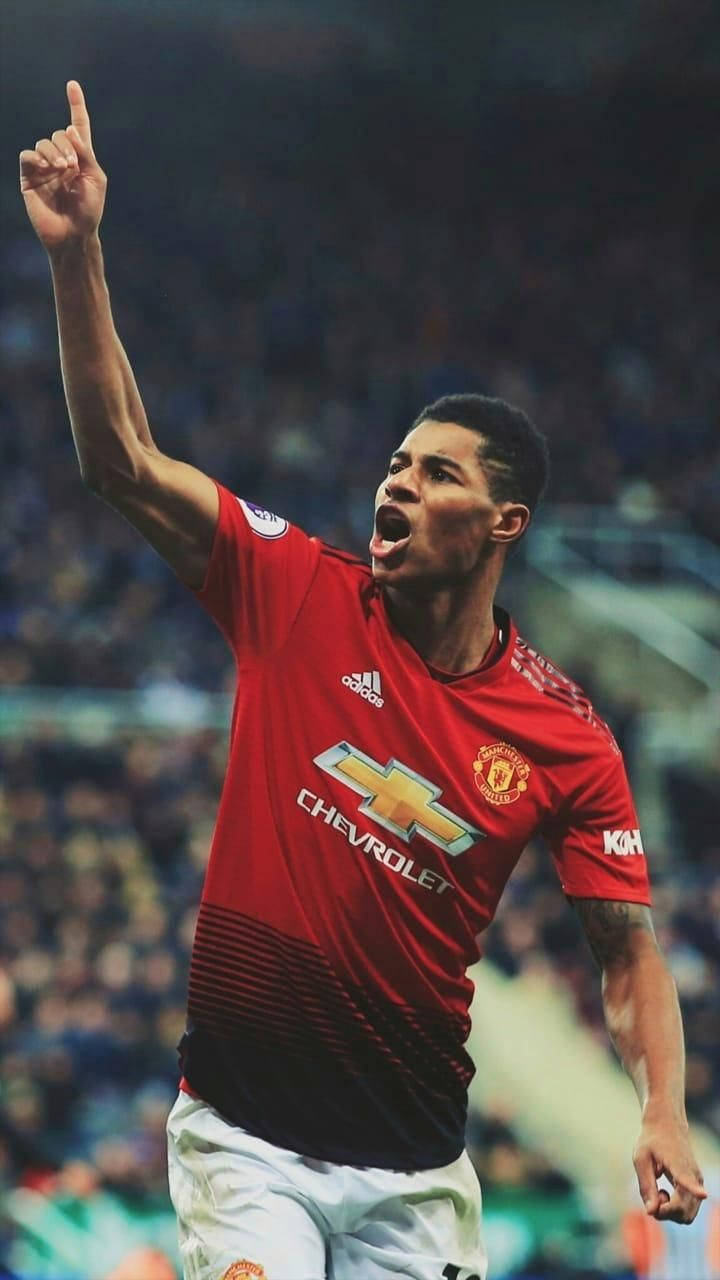 Marcus Rashford Pointing At Sky Background