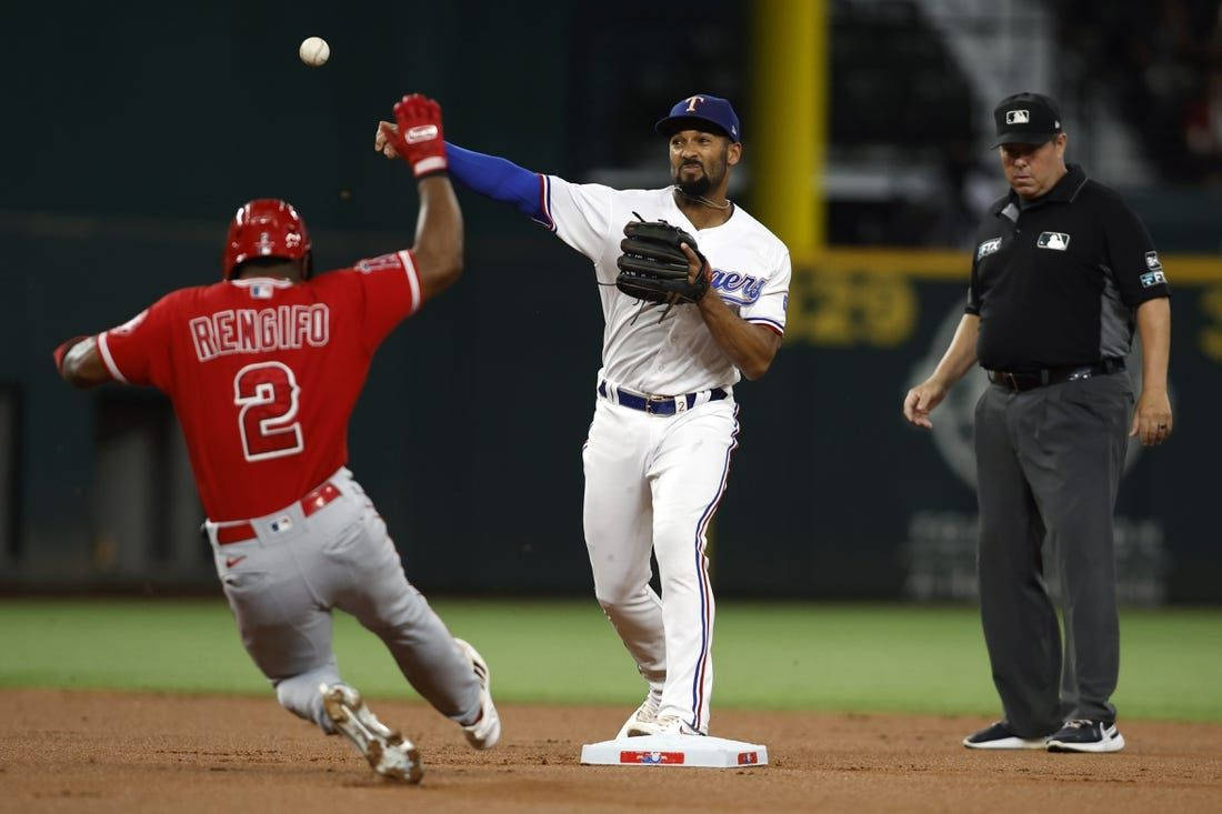 Marcus Semien With Umpire Behind Him Background