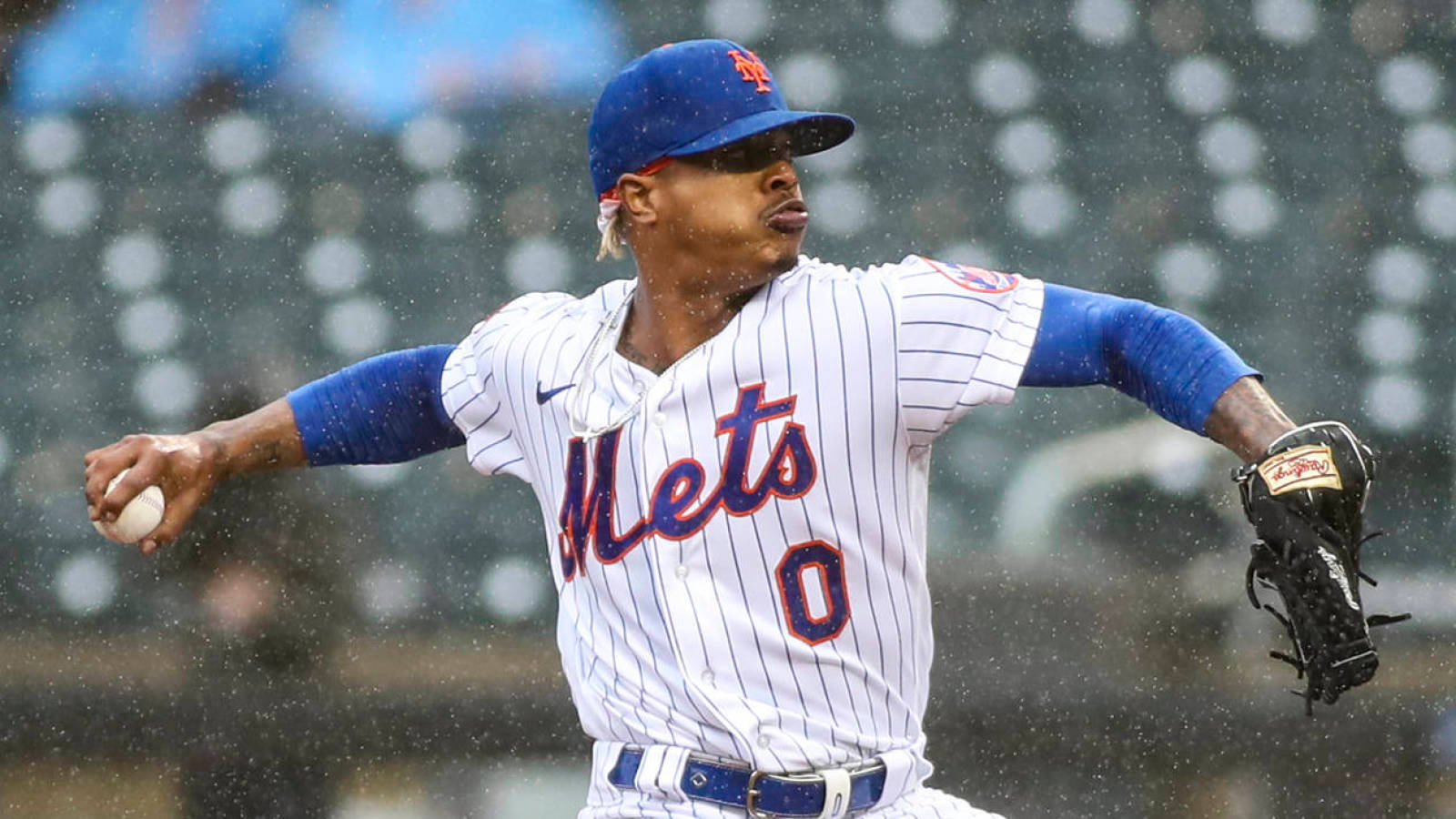 Marcus Stroman Throwing Ball In Rain Background