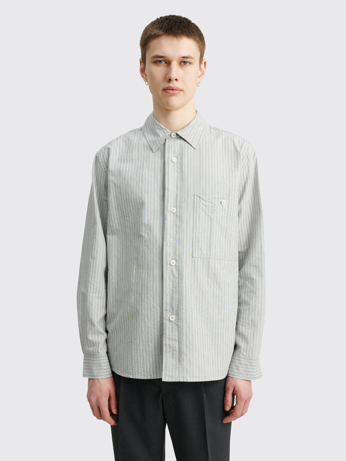 Margaret Howell's Light Gray Striped Polo Shirt Reflecting Minimalistic And Chic Style. Background