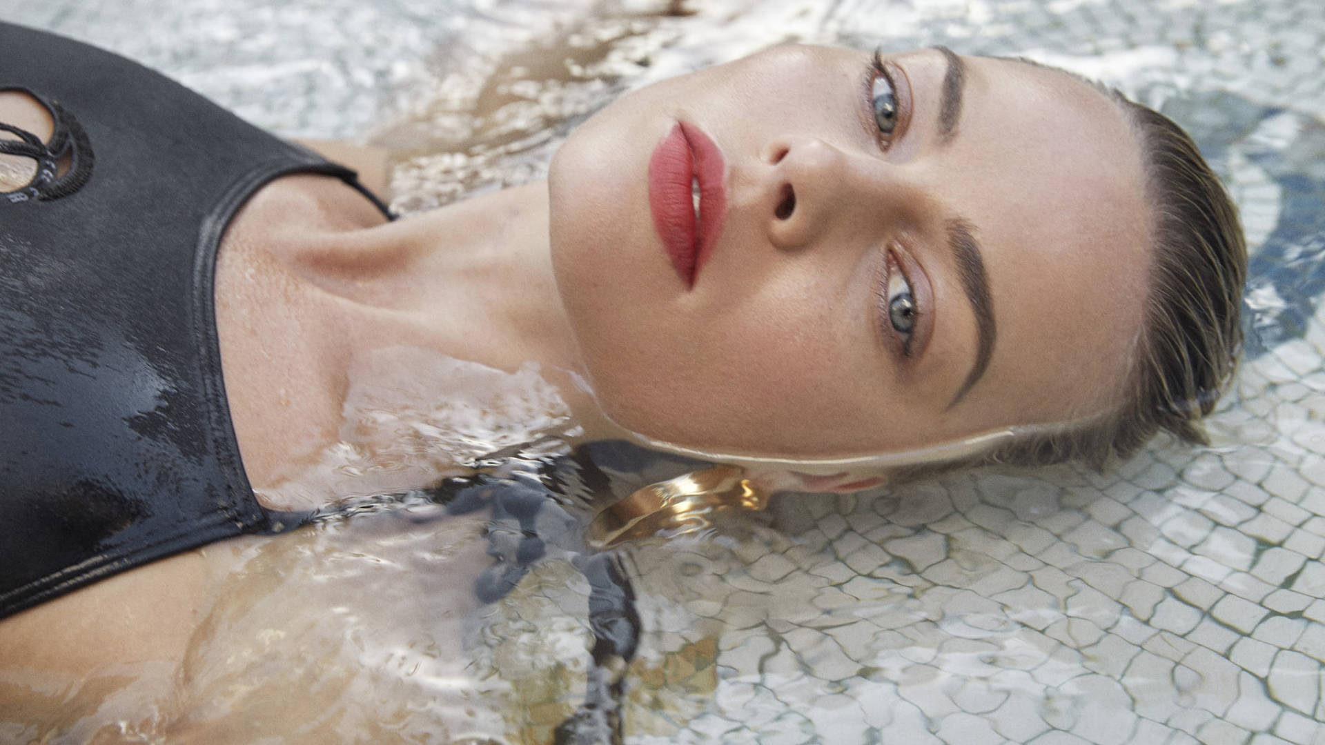 Margot Robbie Lying On Water Background