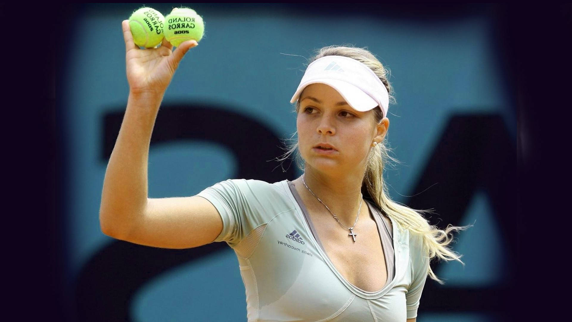 Maria Kirilenko Skillfully Holding Two Tennis Balls Background