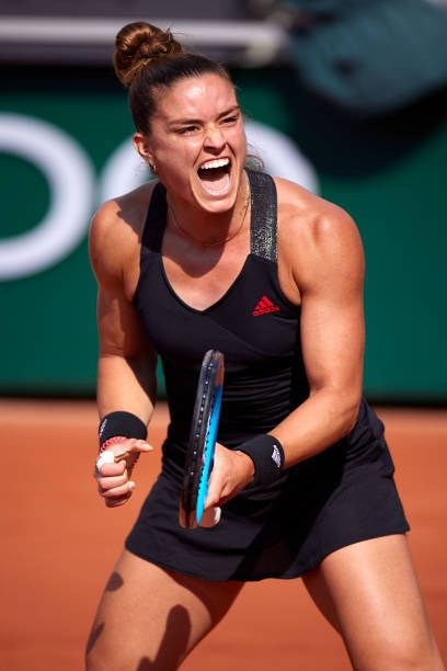 Maria Sakkari Exhibiting Her Strong Forehand Stroke On The Tennis Court. Background