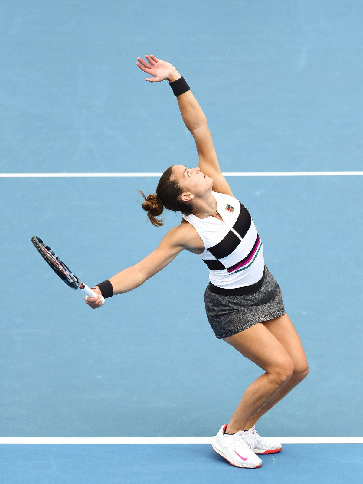 Maria Sakkari Hitting Tennis Ball To Serve Background