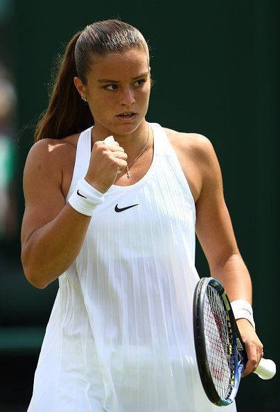 Maria Sakkari In Action During A Tennis Match Background