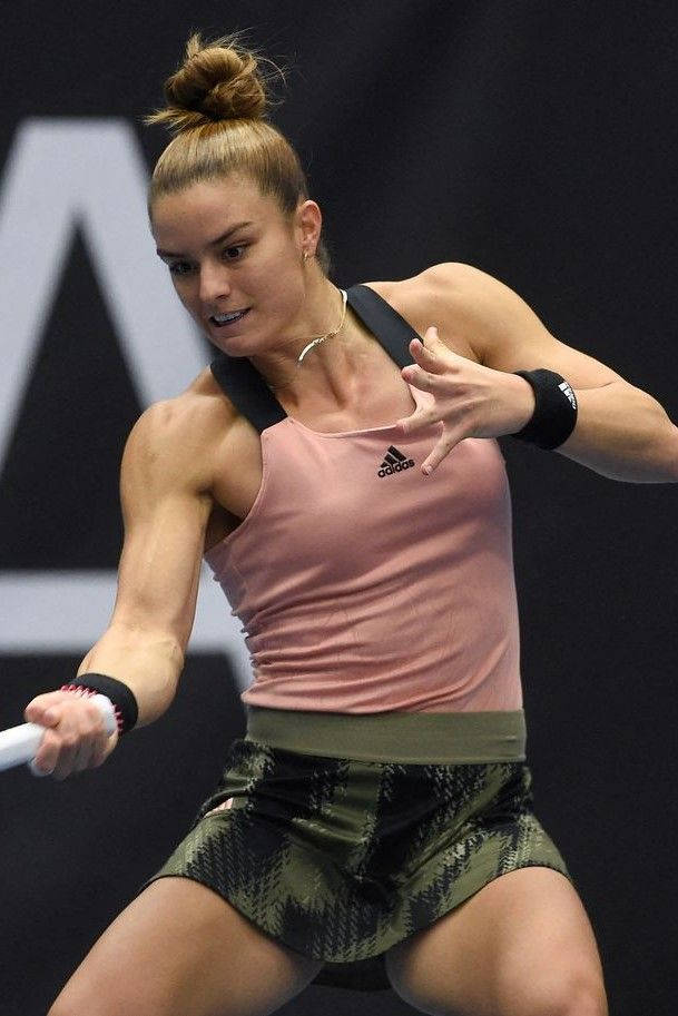 Maria Sakkari In Action - Reaching For A Forehand Background