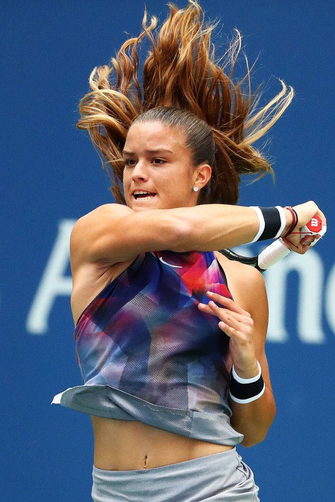 Maria Sakkari In Action With Hair Flying Background