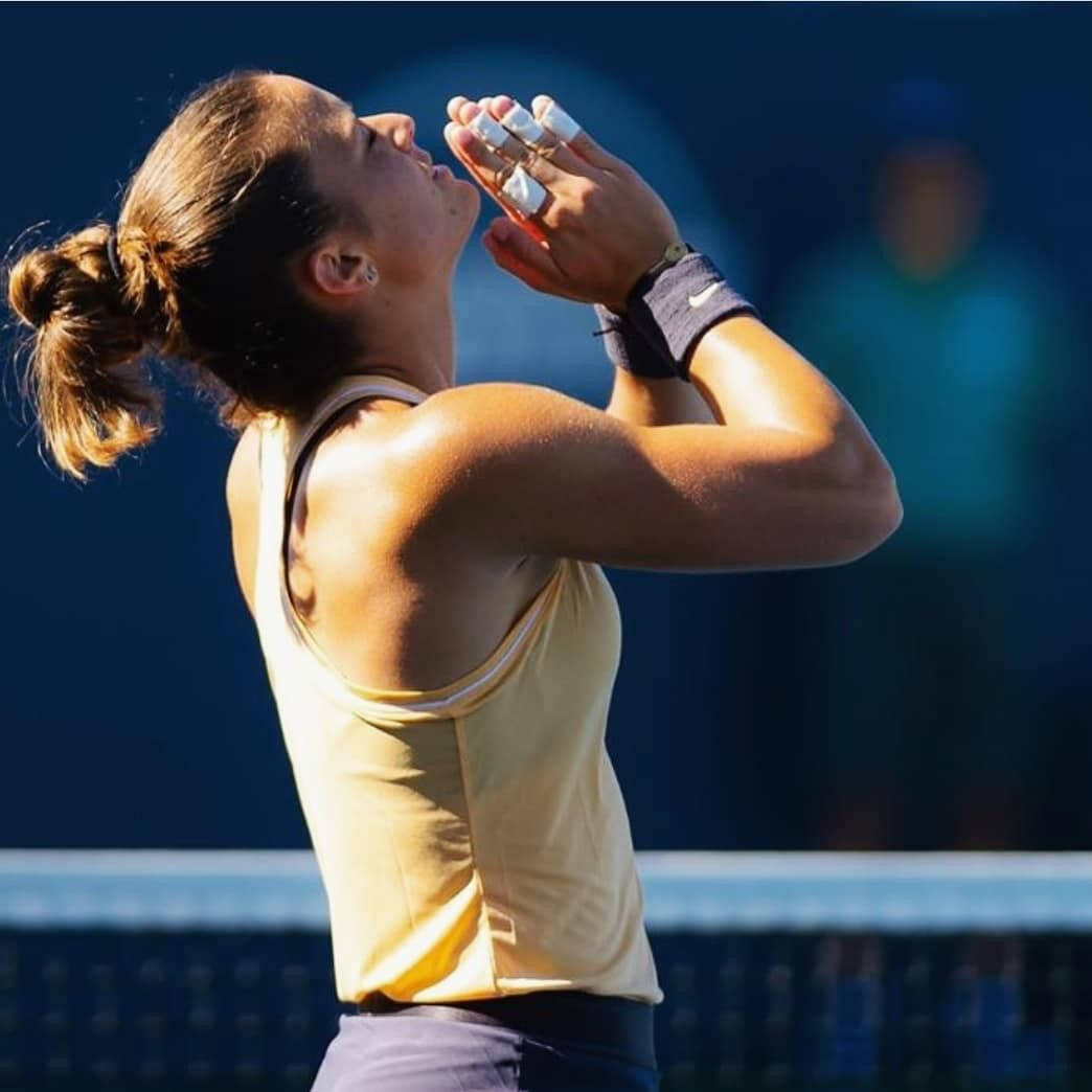 Maria Sakkari Pressing Hands Together During A Match Background