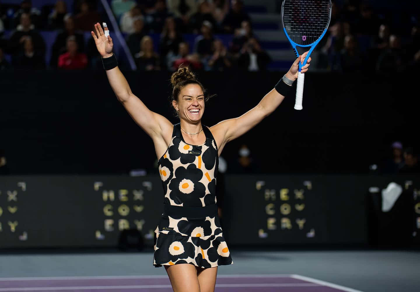 Maria Sakkari Smiling With Arms Raised Background