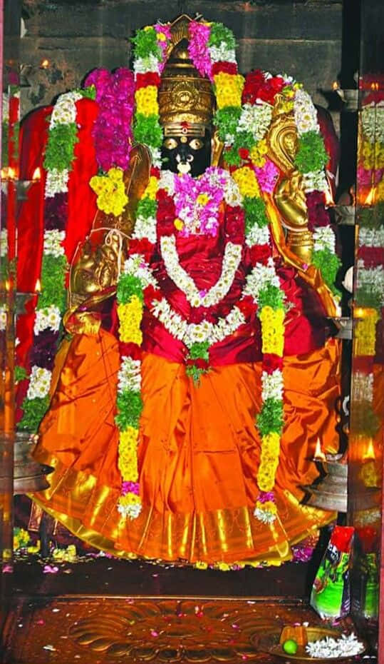 Mariamman Hindu Goddess Statue Adorned With Flowers