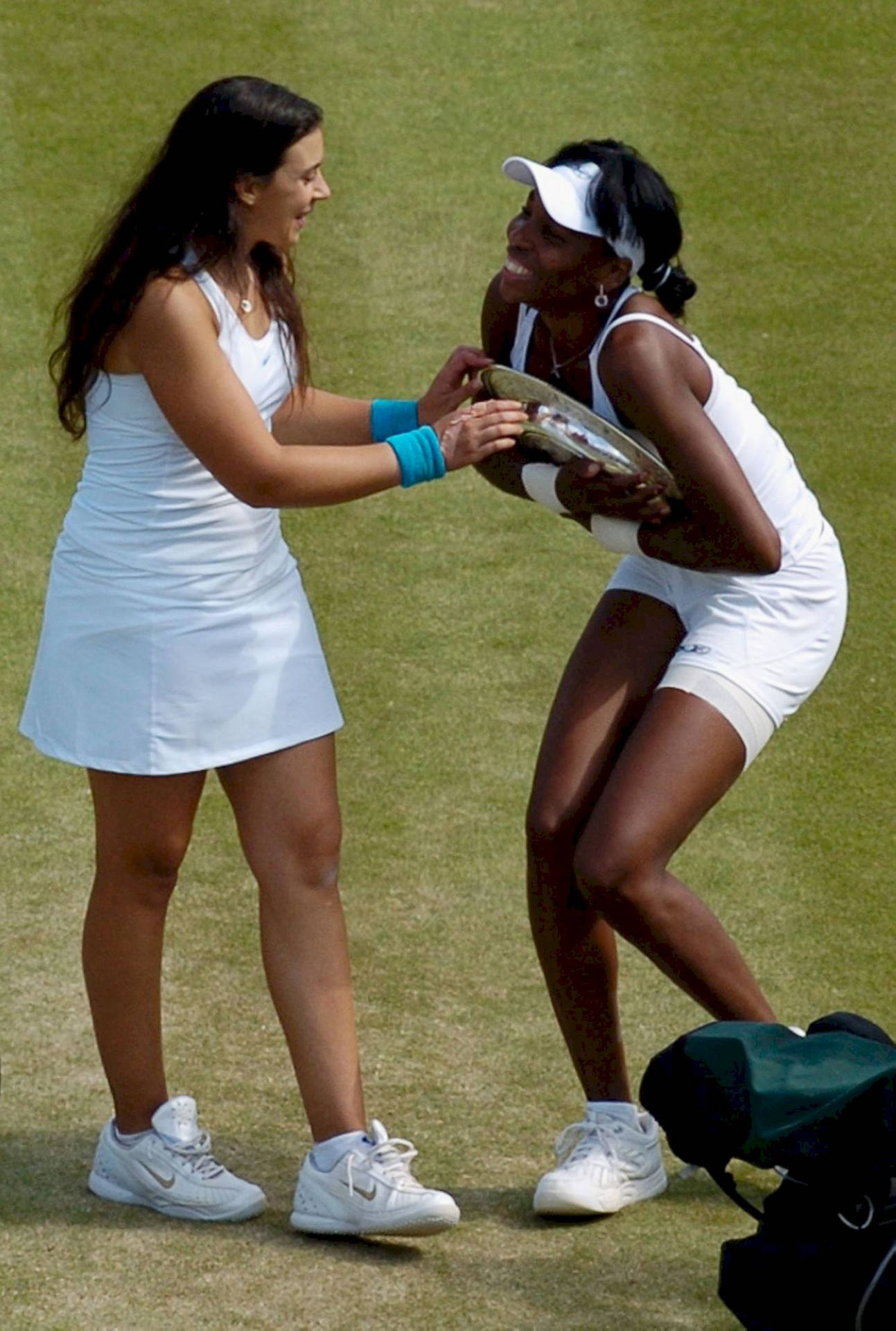 Marion Bartoli And Venus Williams During A Tennis Match.