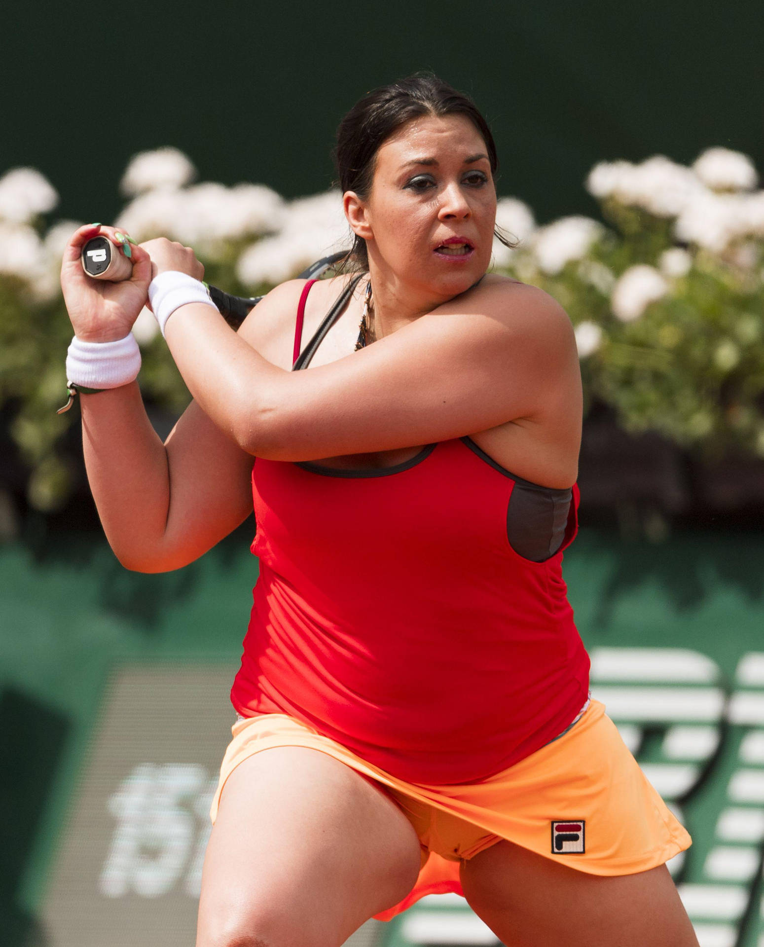 Marion Bartoli During A Tennis Match In A Vibrant Red Top