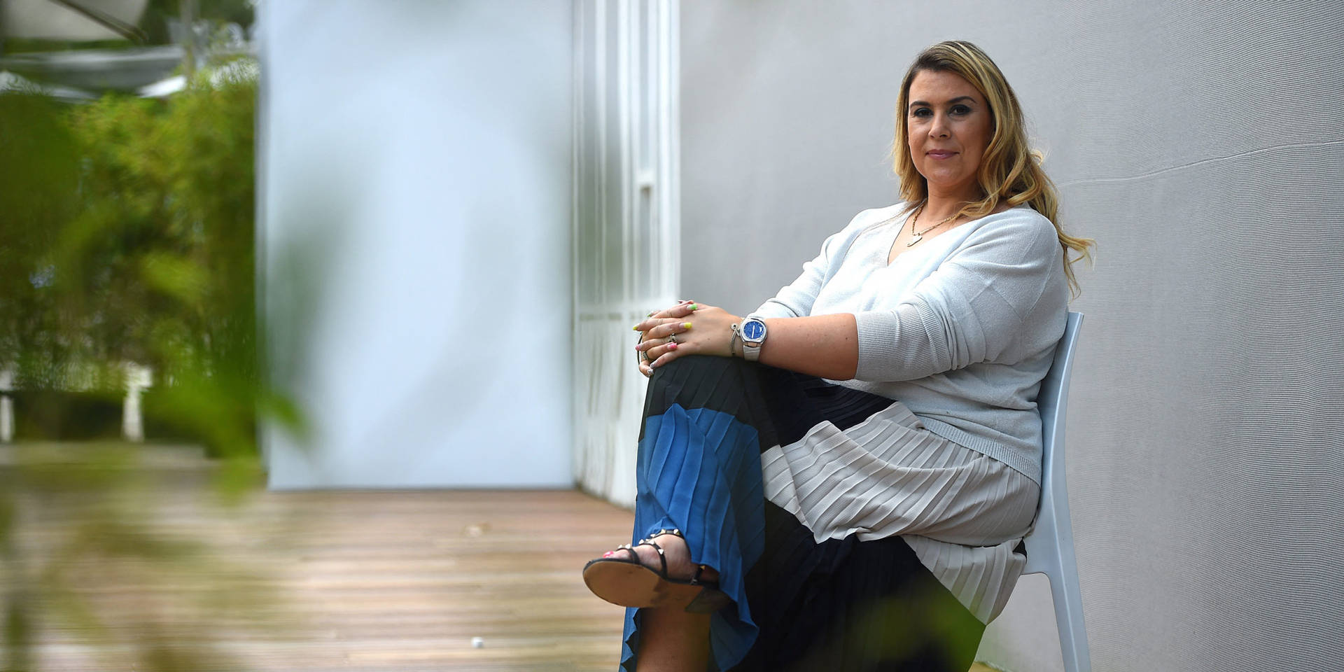 Marion Bartoli Sitting Serenely In A Styled Outfit Background