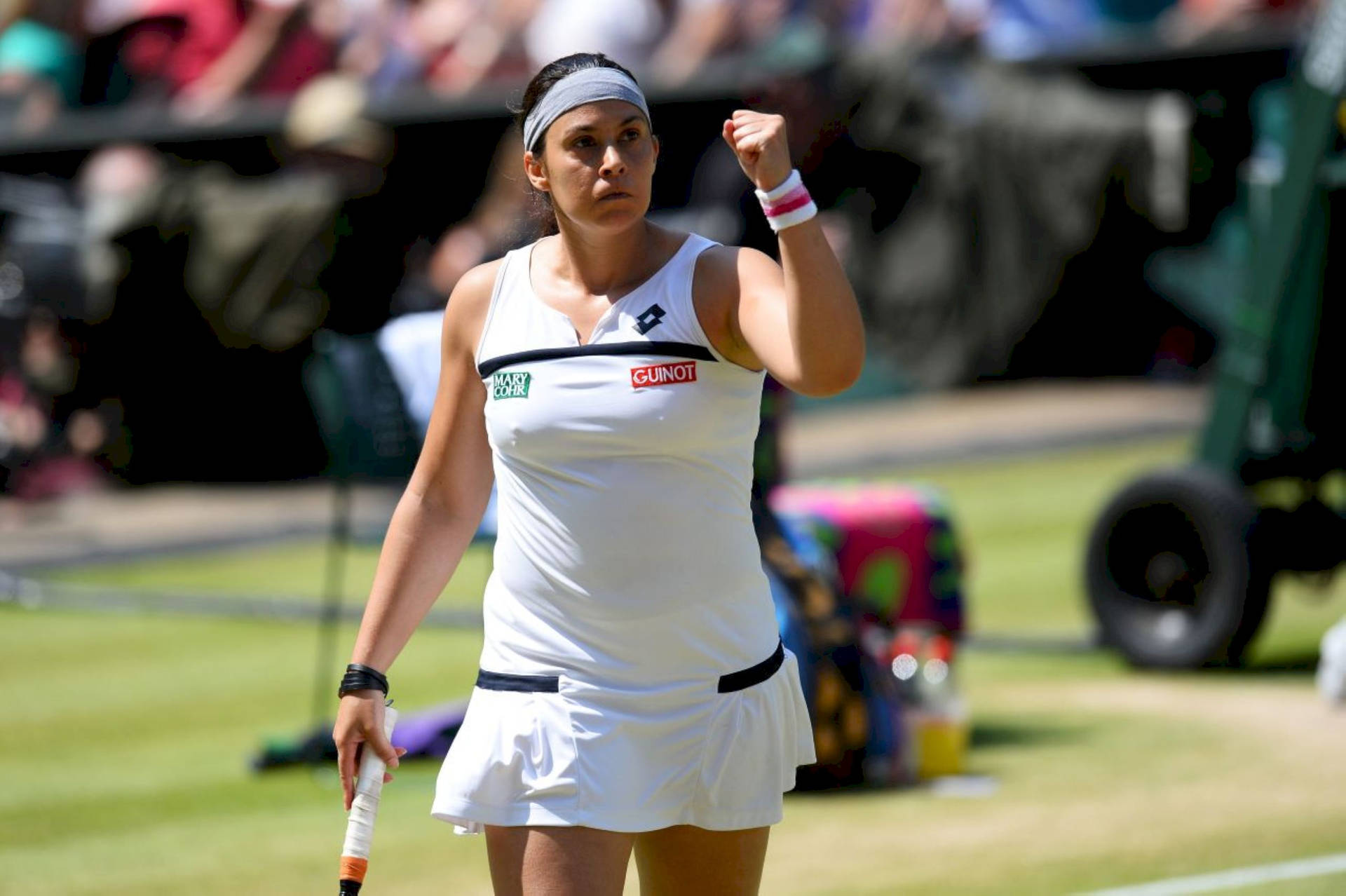 Marion Bartoli Triumphantly Fist Pumps On The Tennis Court Background