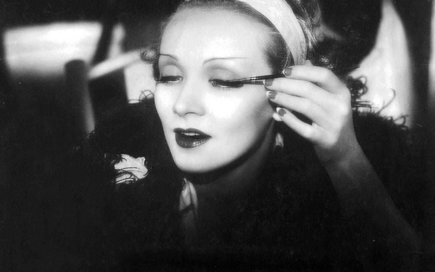 Marlene Dietrich Applying Mascara Background