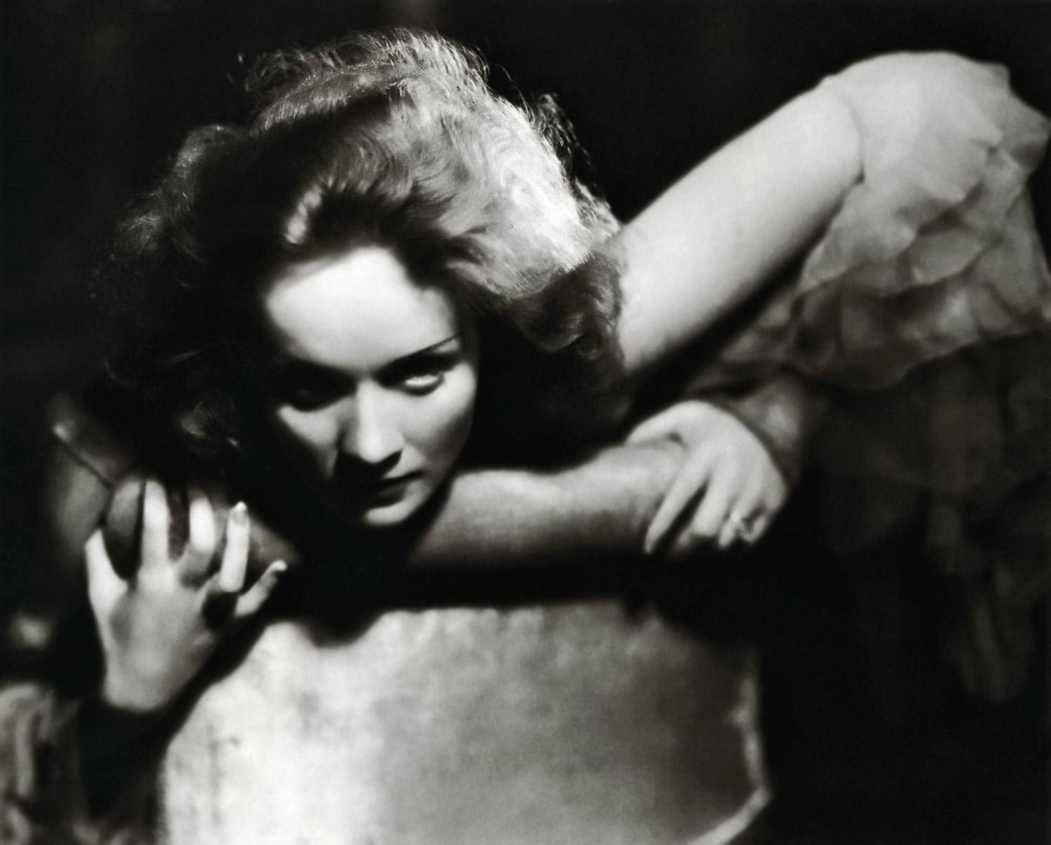 Marlene Dietrich Clinging Onto Chair Background