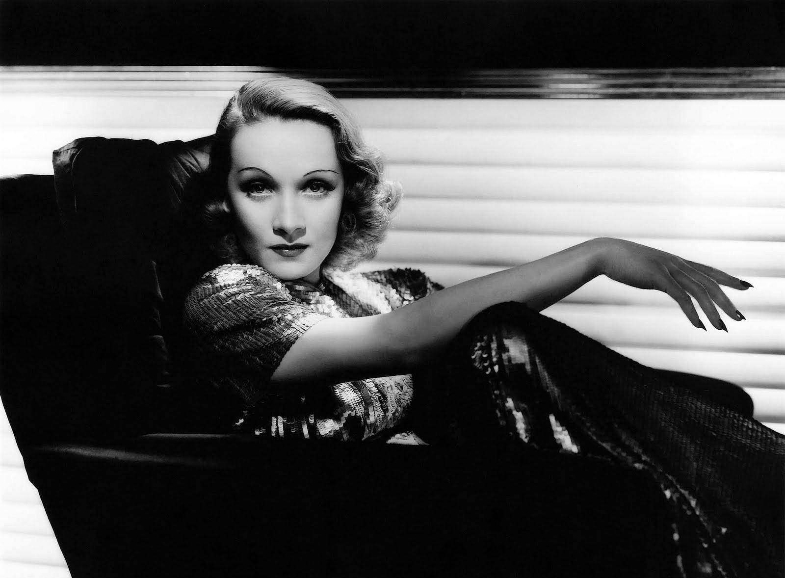 Marlene Dietrich Lounging On Chair Background