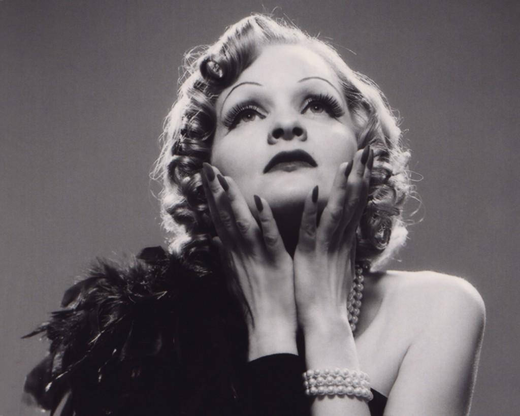 Marlene Dietrich Posing In Black Feather Dress Background