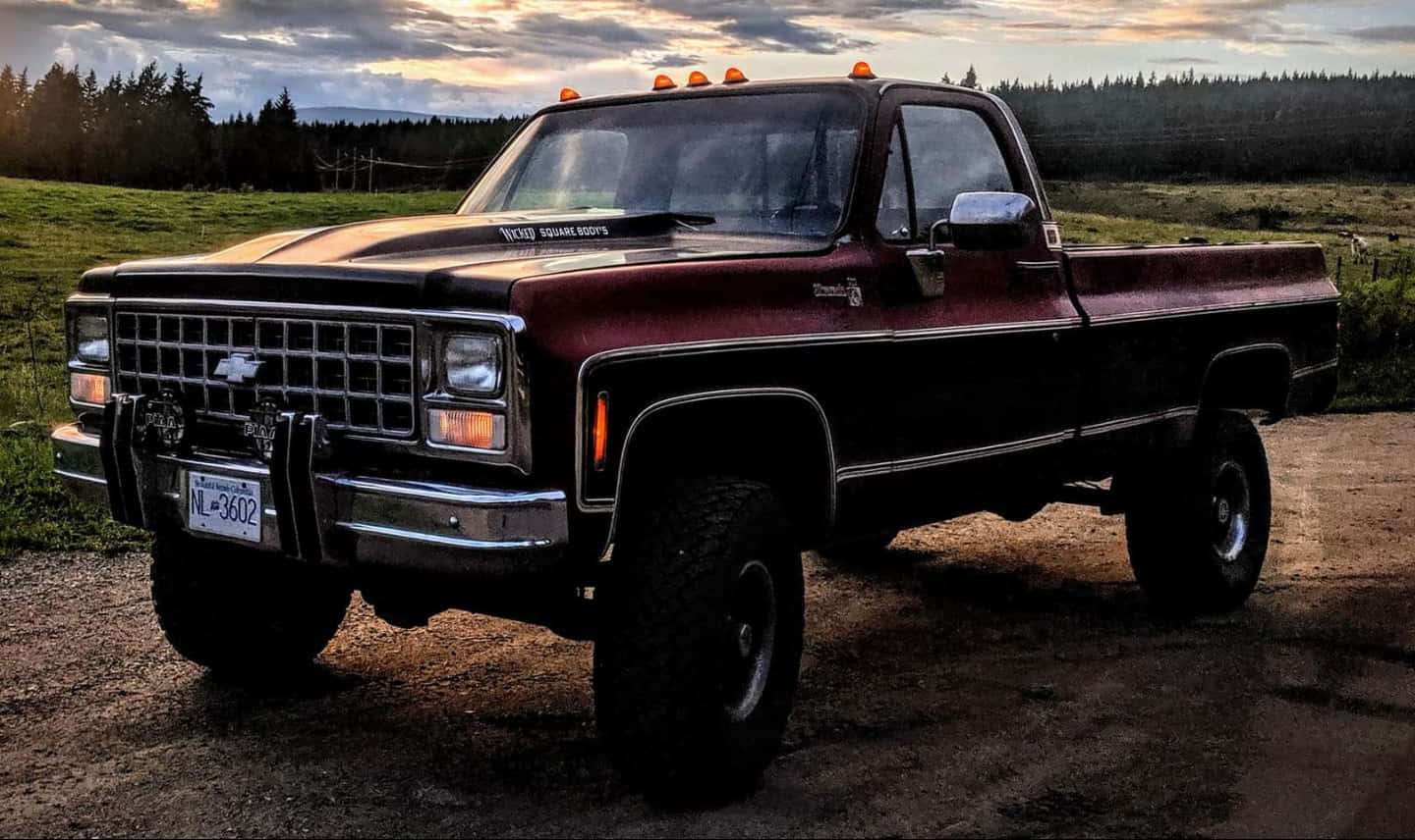 Maroon Jacked Up Trucks Background