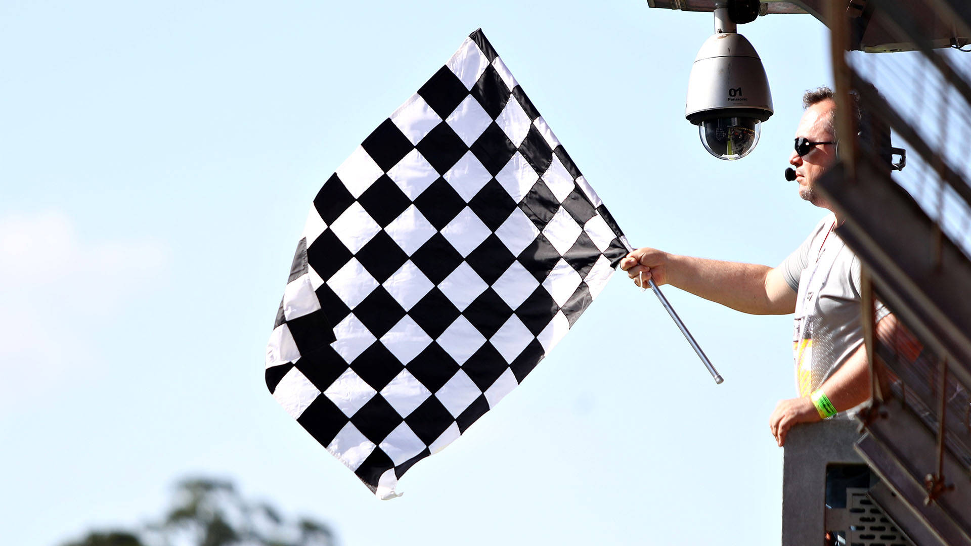 Marshal Holding A Checkered Flag Background