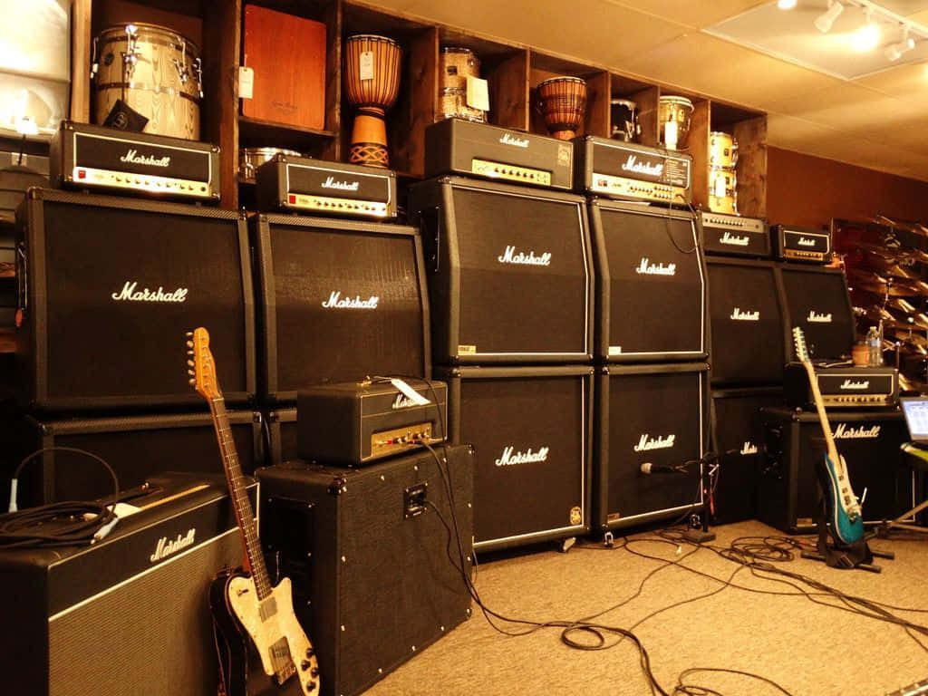Marshall Amps In A Room With Guitars And Amps Background