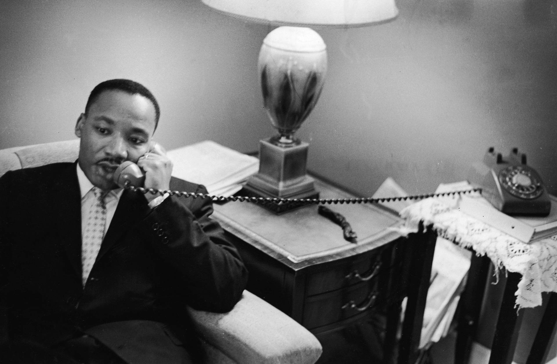 Martin Luther King Jr. Engaging In A Thought-provoking Phone Call Background