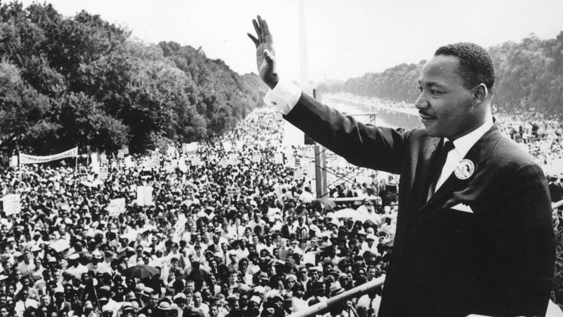 Martin Luther King Jr Waving To Crowd Background