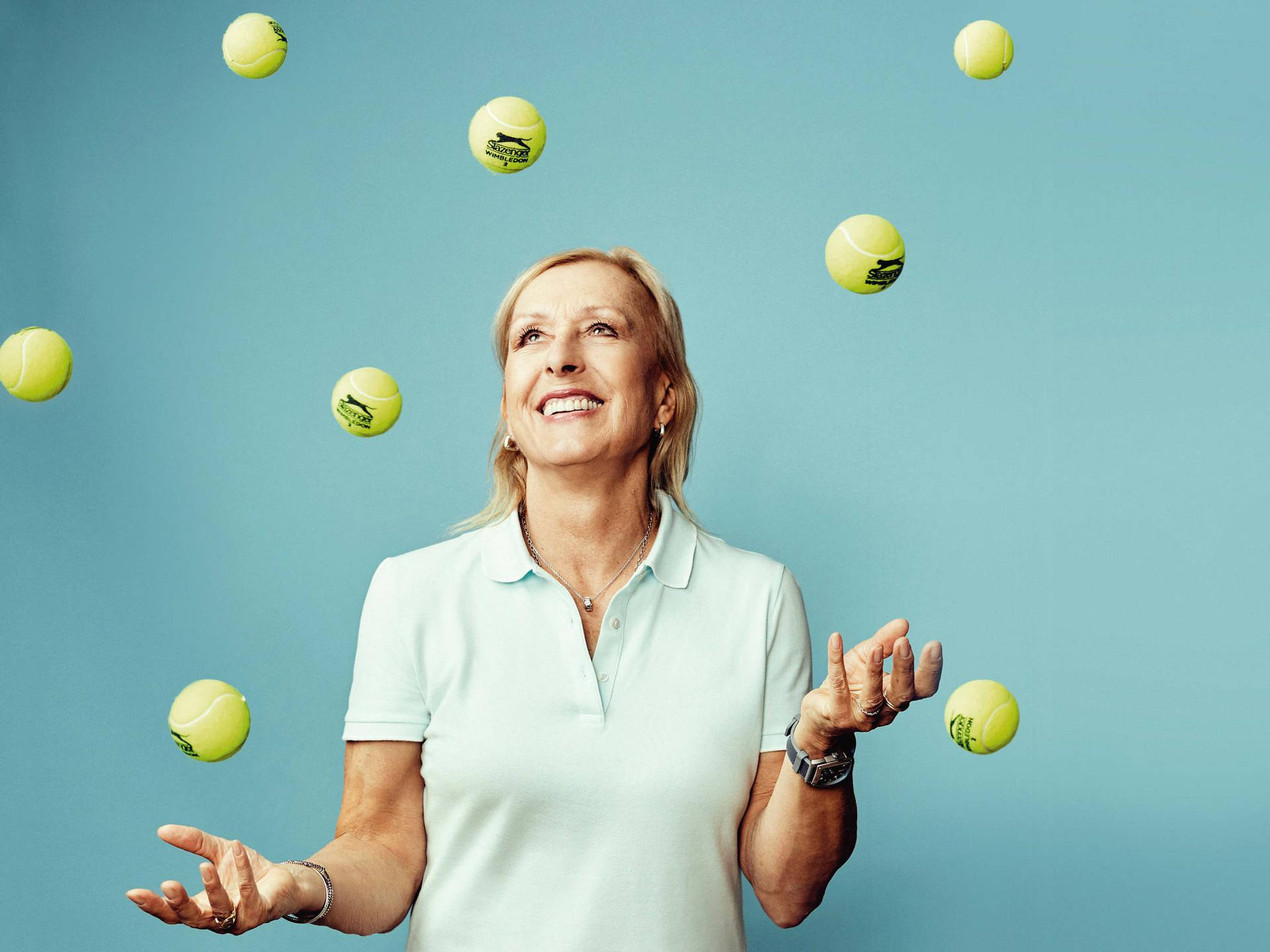 Martina Navratilova Surrounded By Tennis Balls Background