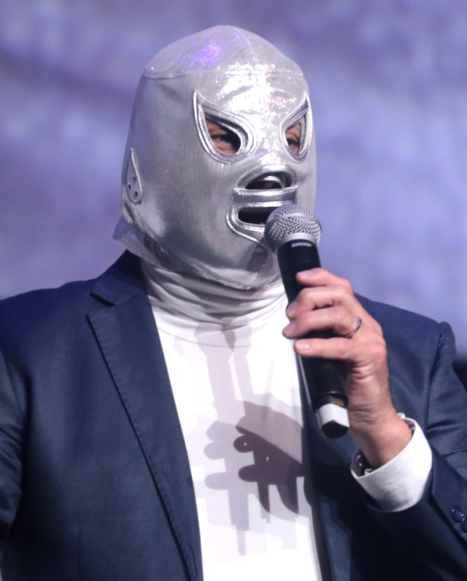 Masked_ Speaker_at_ Event.jpg Background