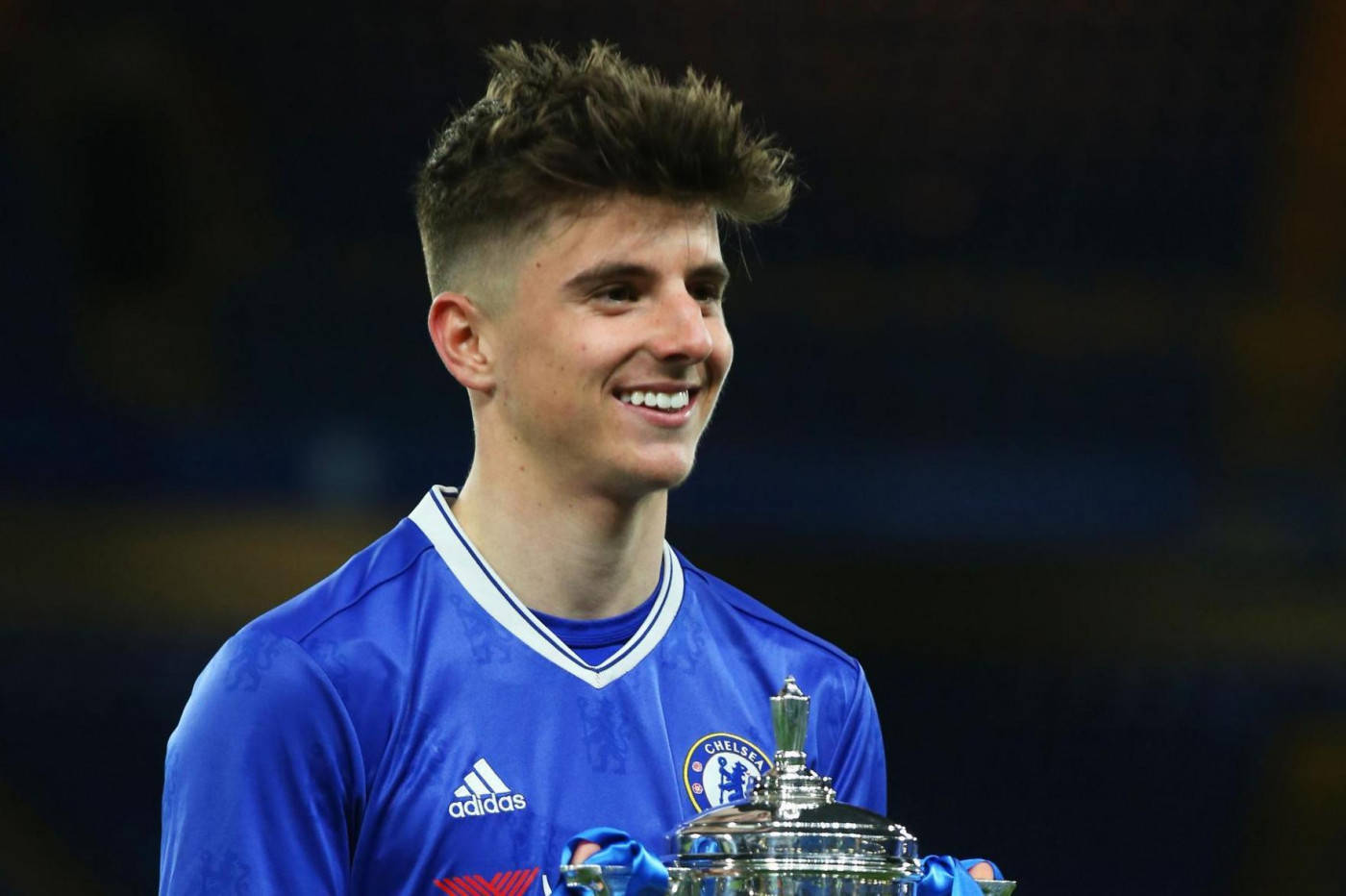 Mason Mount In A Blue Jersey Radiating Confidence Background