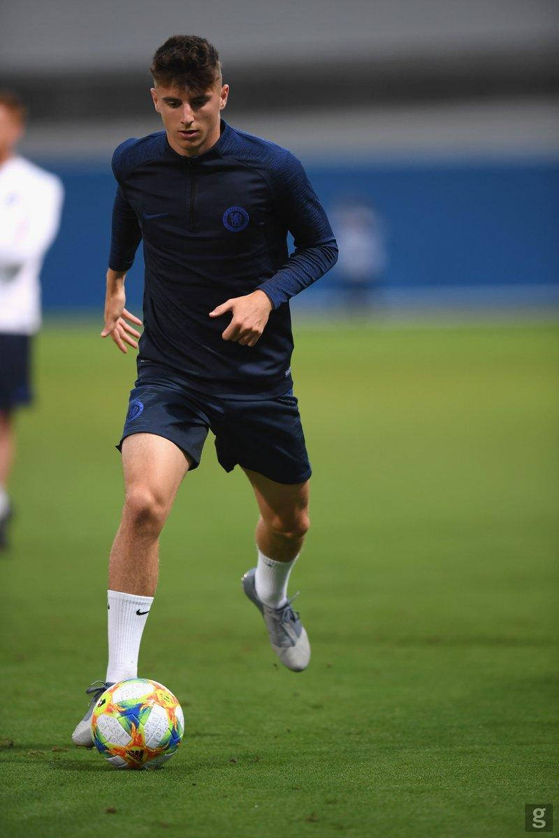 Mason Mount In Dark Blue Kicking The Ball Background