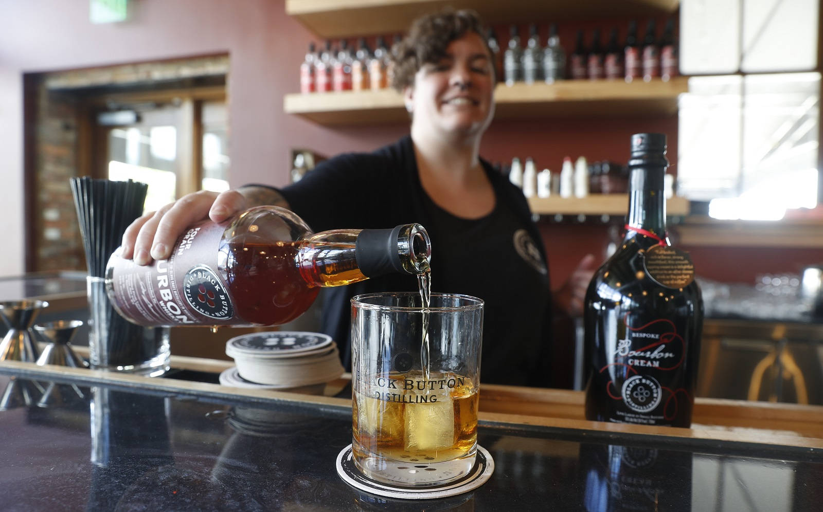 Master Bartender Refilling At Black Button Distilling Background