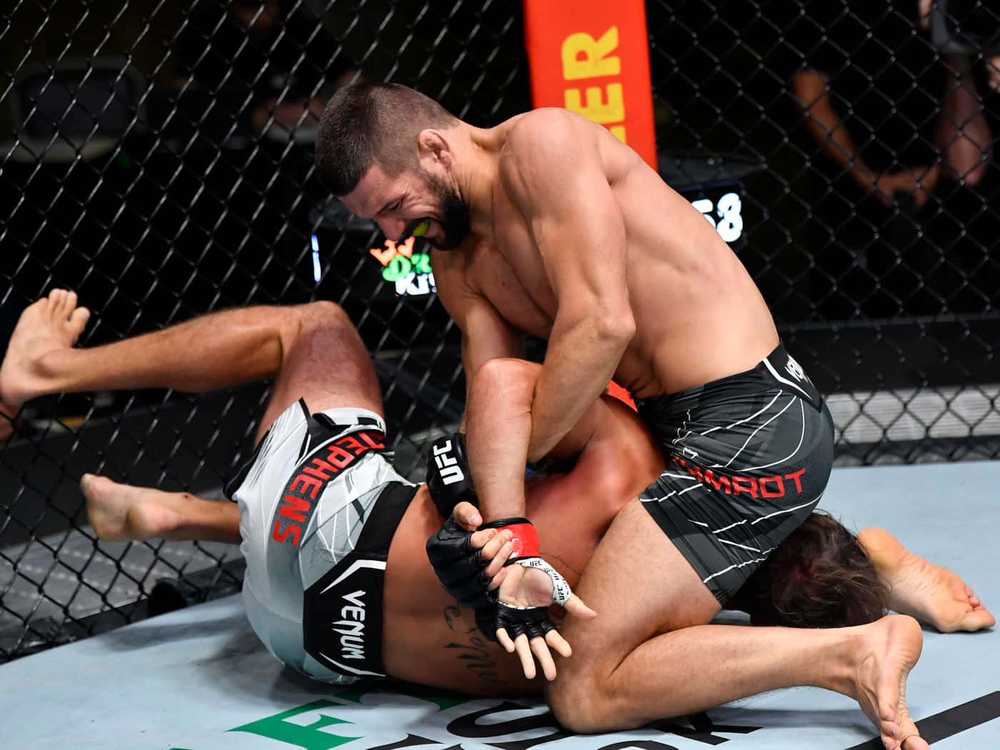 Mateusz Gamrot Tackling An Opponent Background