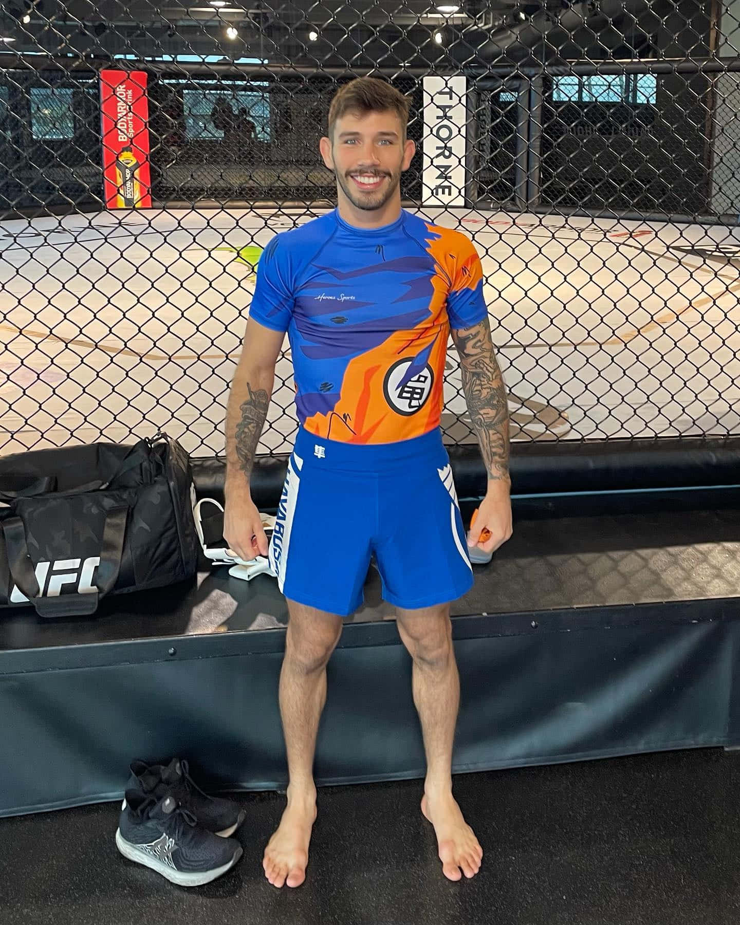 Matheus Nicolau In Orange And Blue Outfit