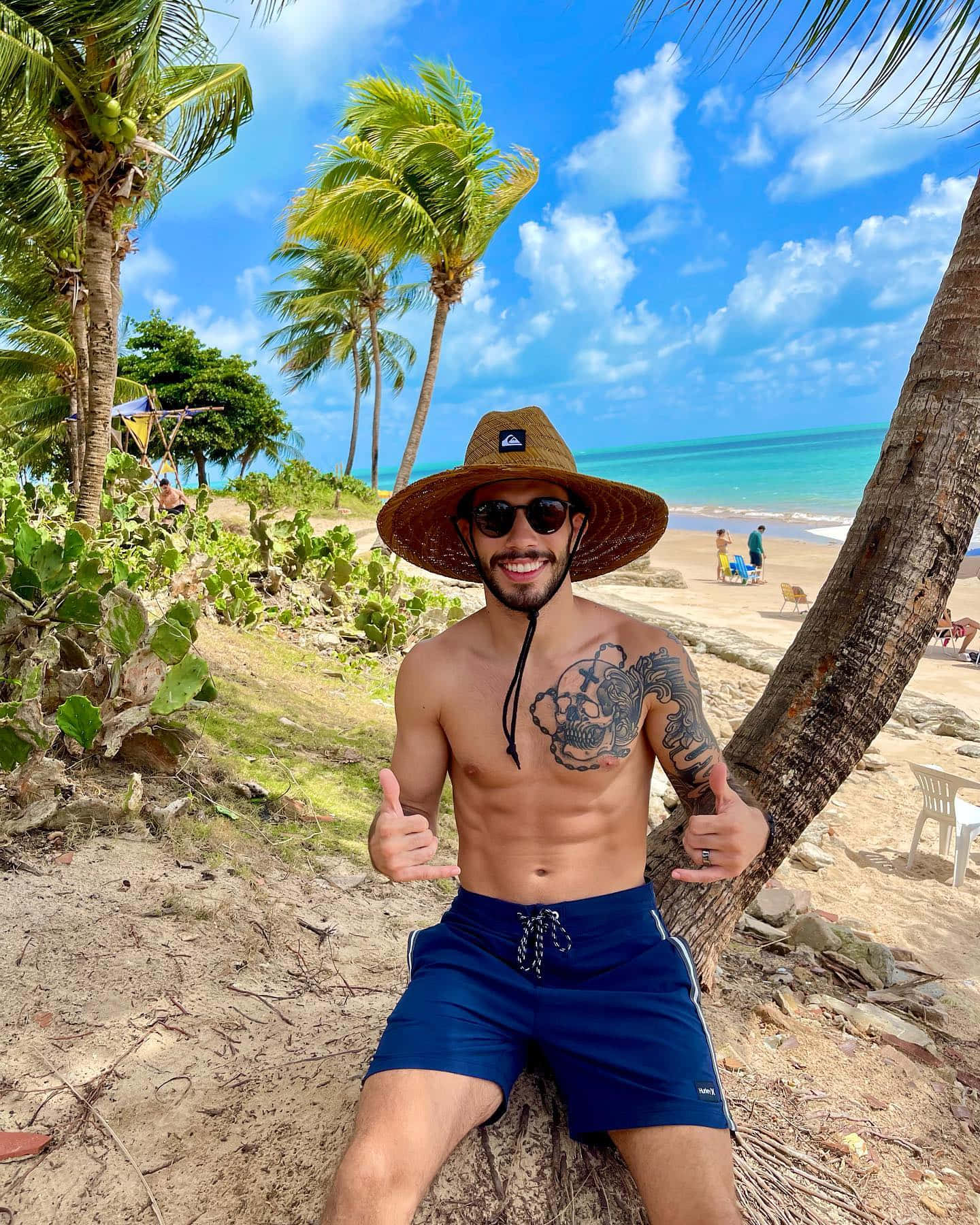 Matheus Nicolau Sitting Beside A Palm Tree