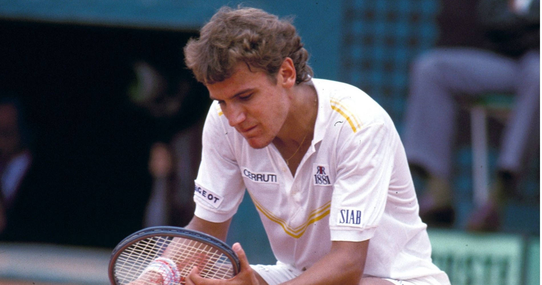 Mats Wilander Inspecting Tennis Racket Background