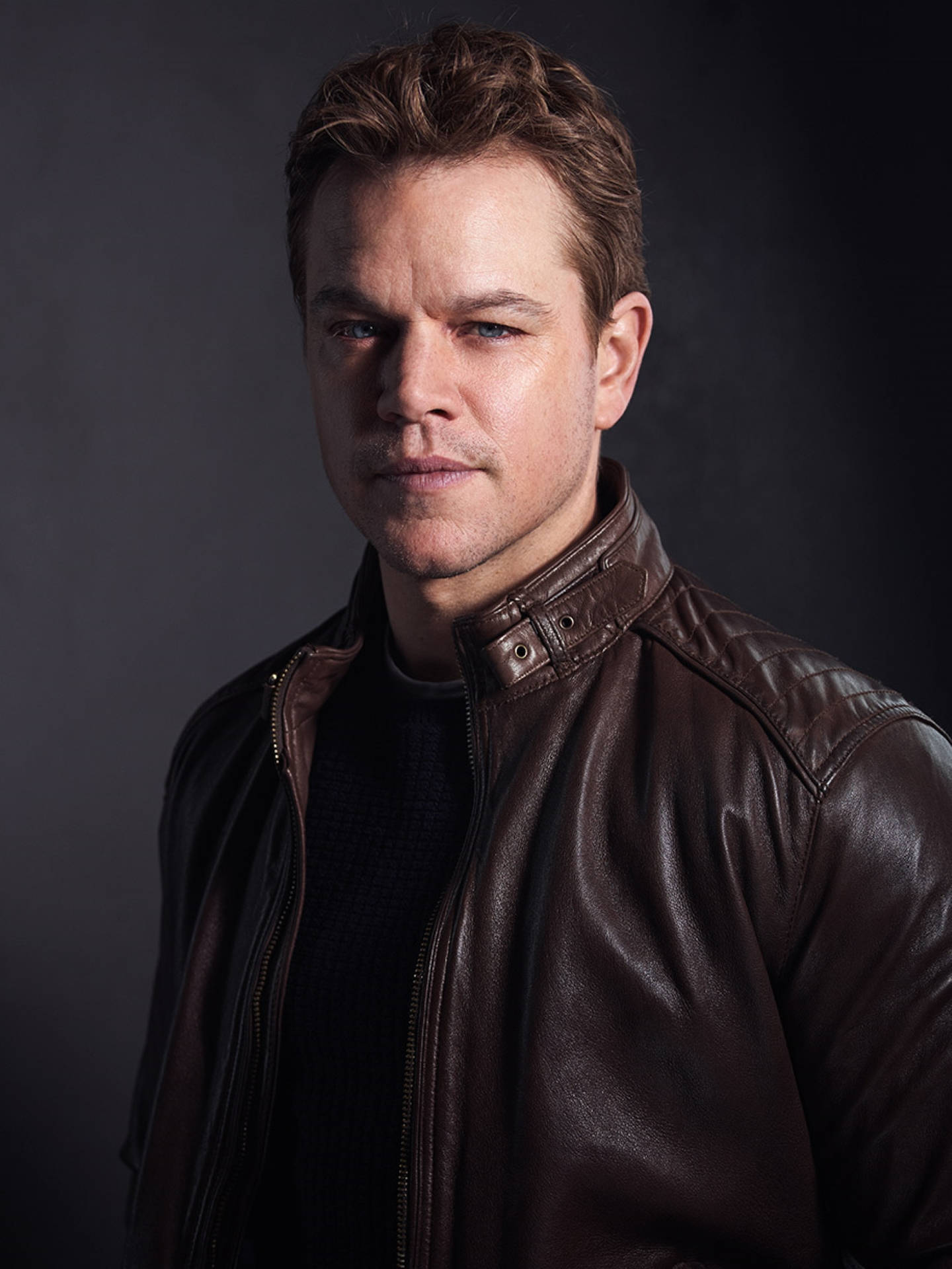 Matt Damon In Brown Leather Jacket Background