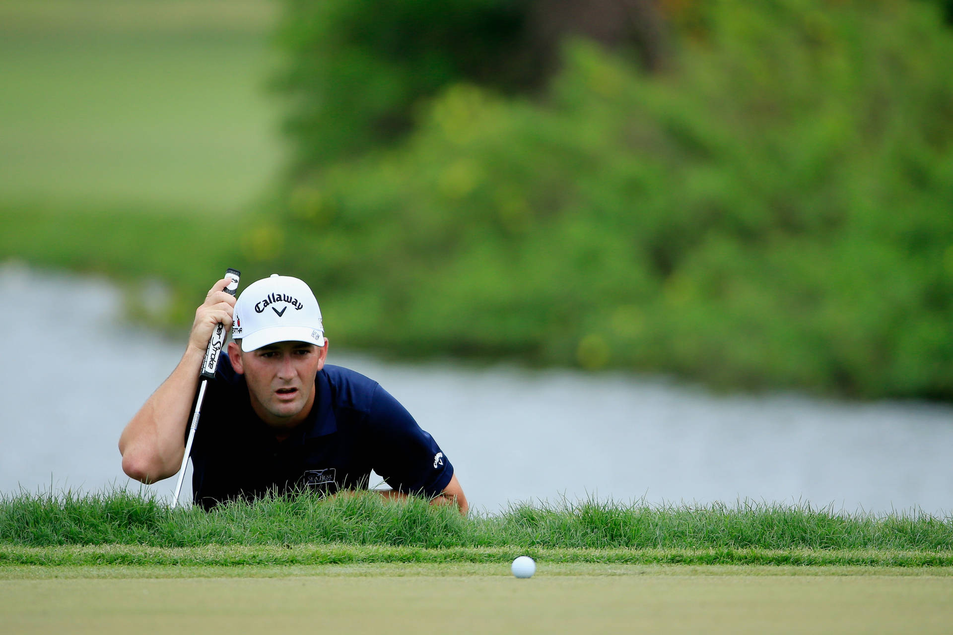 Matt Every Examining Golf Ball Background