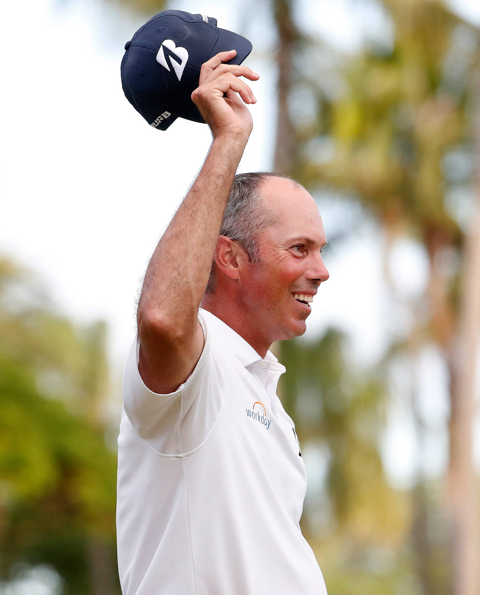 Matt Kuchar Holding Black Cap Background