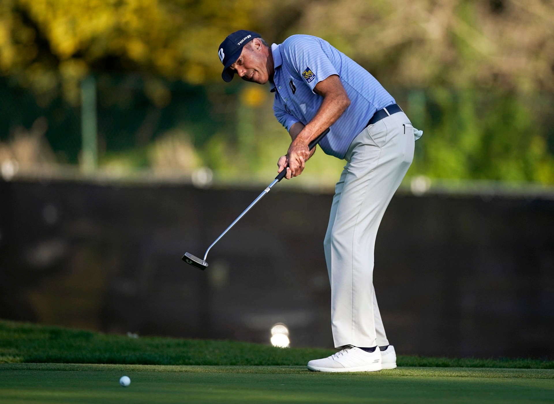 Matt Kuchar Preparing To Hit Ball Background